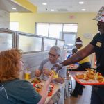 Bojangles chicken franchise staff serving fried chicken