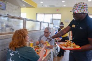 Bojangles chicken franchise staff serving fried chicken